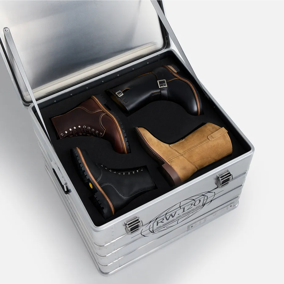 An open metal box against a white background that contains 4 different styles of Red Wing boots