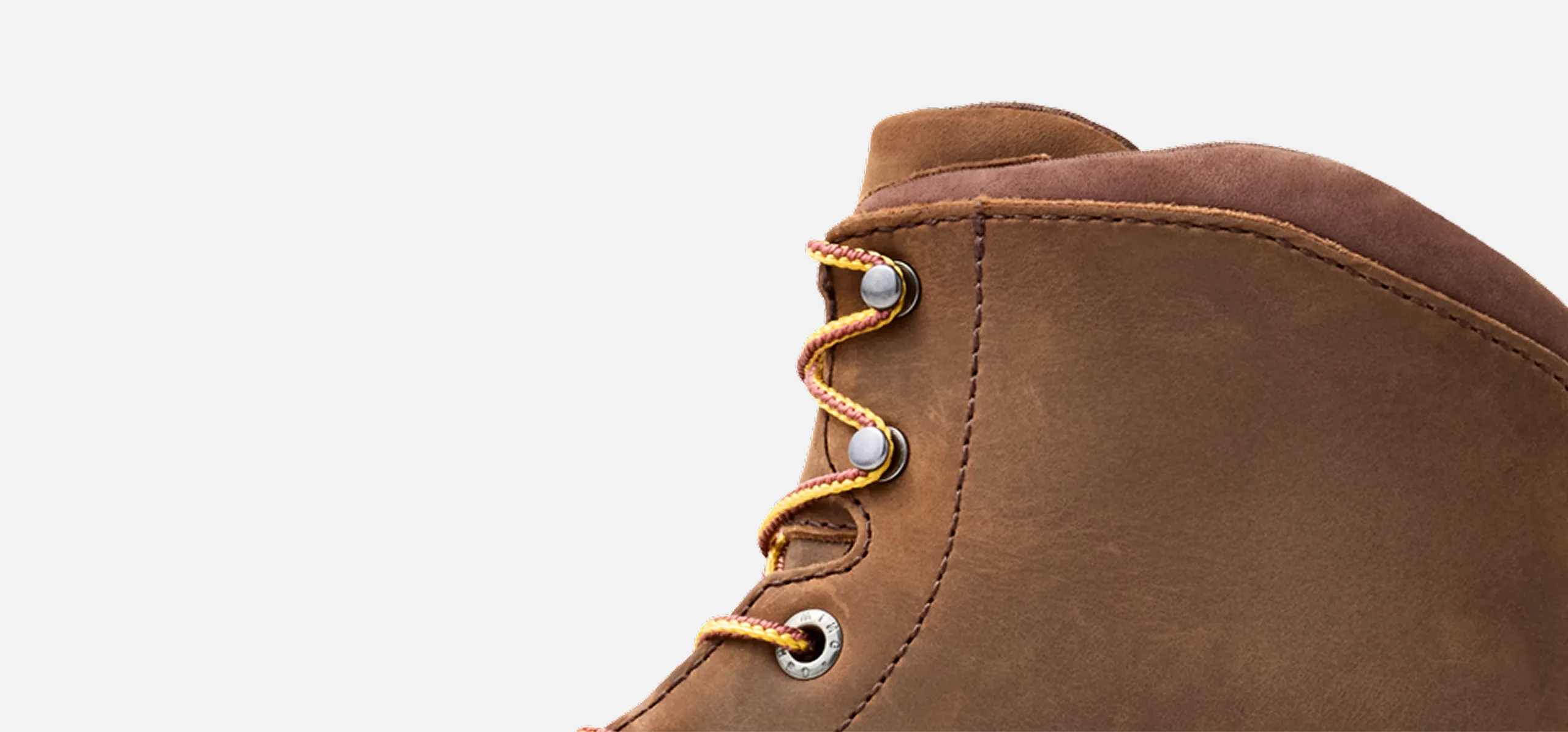 A close up of the top of a boot against a white background