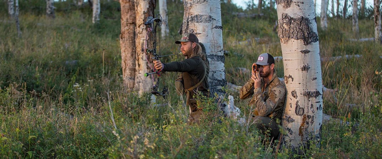 Josh Dickens and a fellow hunter in a field hunting elk