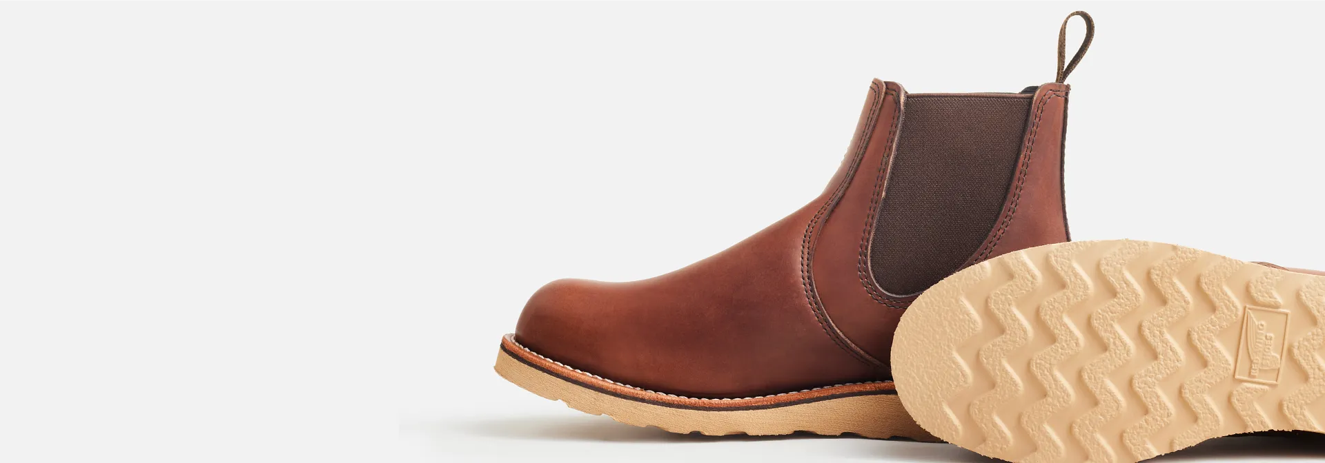 Close up view of the side and the bottom of a pair of shoes against a white background