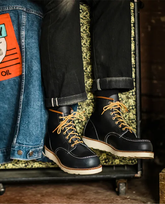 Close up of a person's legs with Red Wing Heritage boots on
