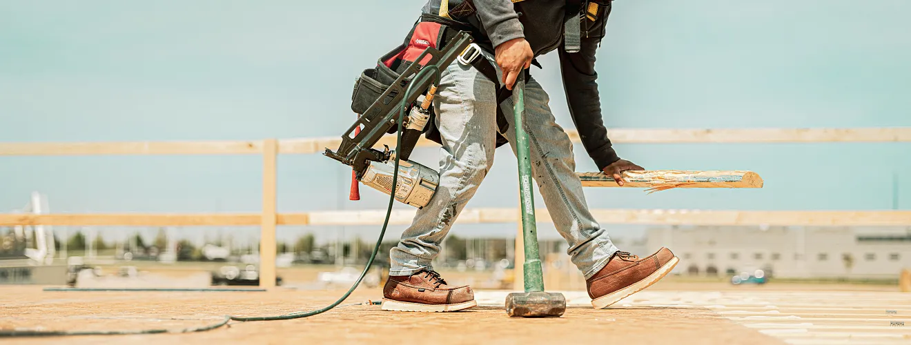 A person at a worksite with a sledgehammer