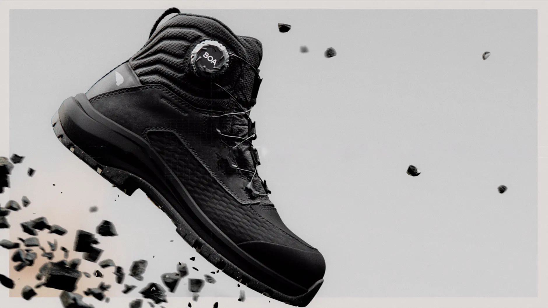 Apex boot floating against a white background with flying debris
