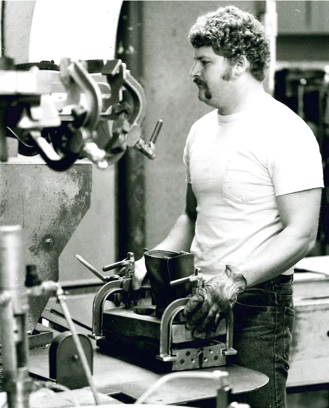 Man working on a boot at a machine