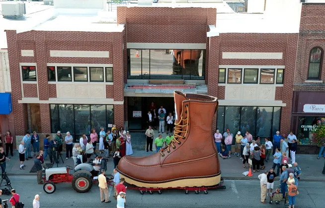 Red Wing Shoes world's largest boot being hauled by a tractor in front of the Red Wing Shoe Store