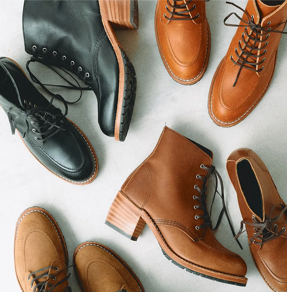 Overhead view of several shoes laying on a white table