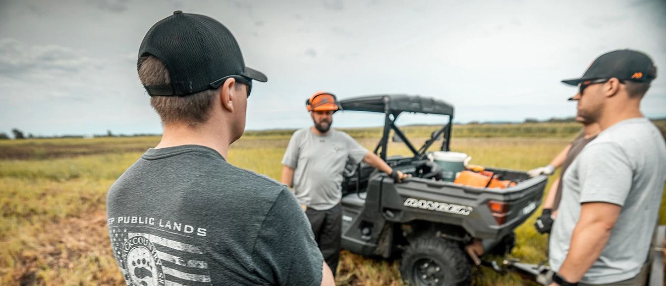 Aaron Hebeisen and another hunter talking in a field