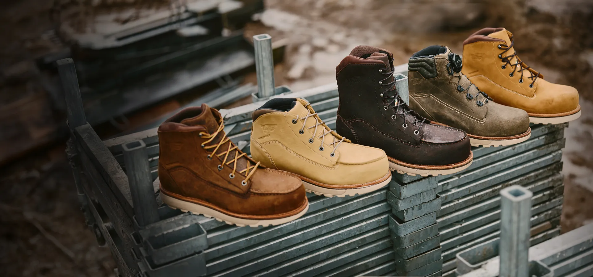 Five different Traction Tred Lite boots lined up on a pile of metal