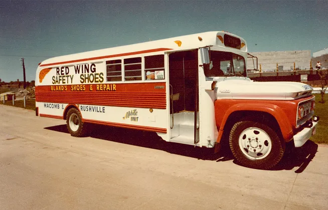 Historical photo of Red Wing Shoes first mobile shoe bus parked at a jobsite