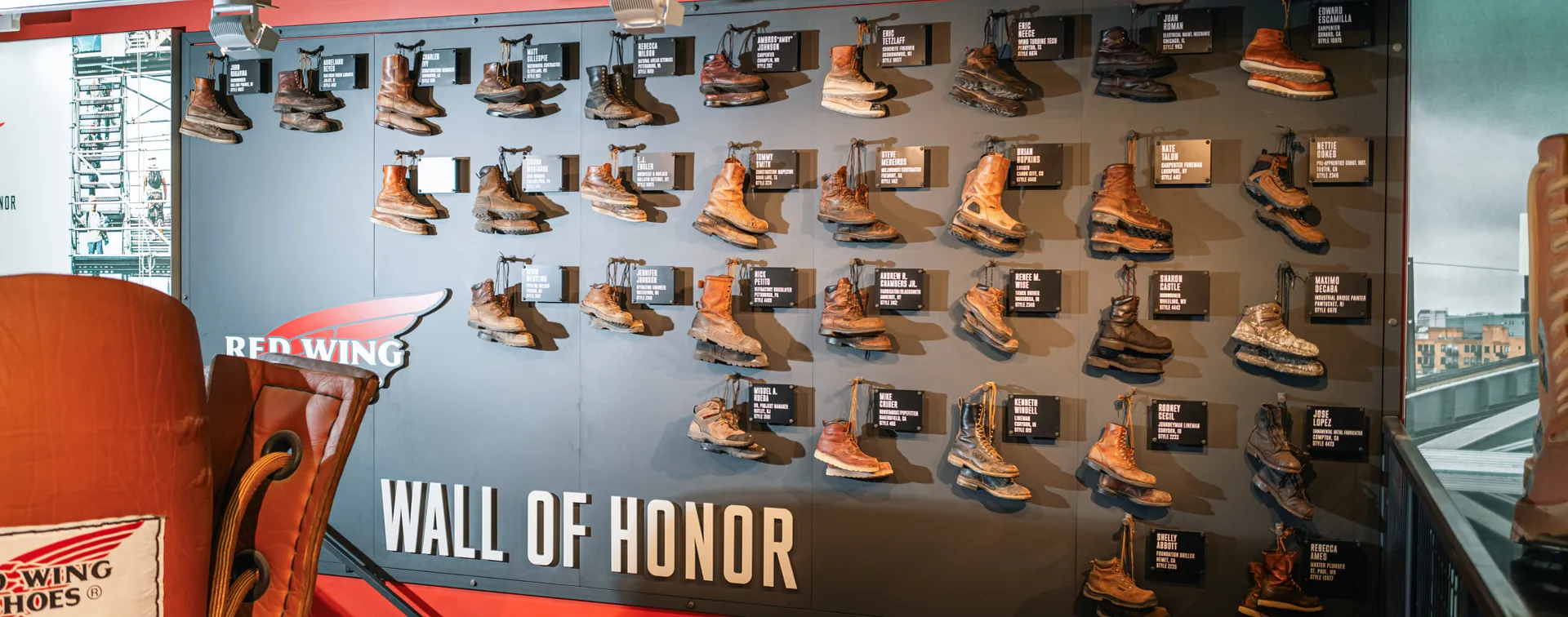 The Wall of Honor with all the honoree's boots hanging on the wall with their plaques next to them