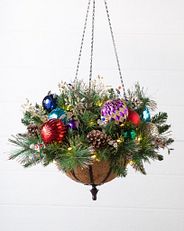 a hanging basket with artificial greenery and multicolored decorations