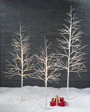 Three artificial birch twig trees with LED lights