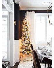 slim Christmas tree with decorations in the dining room