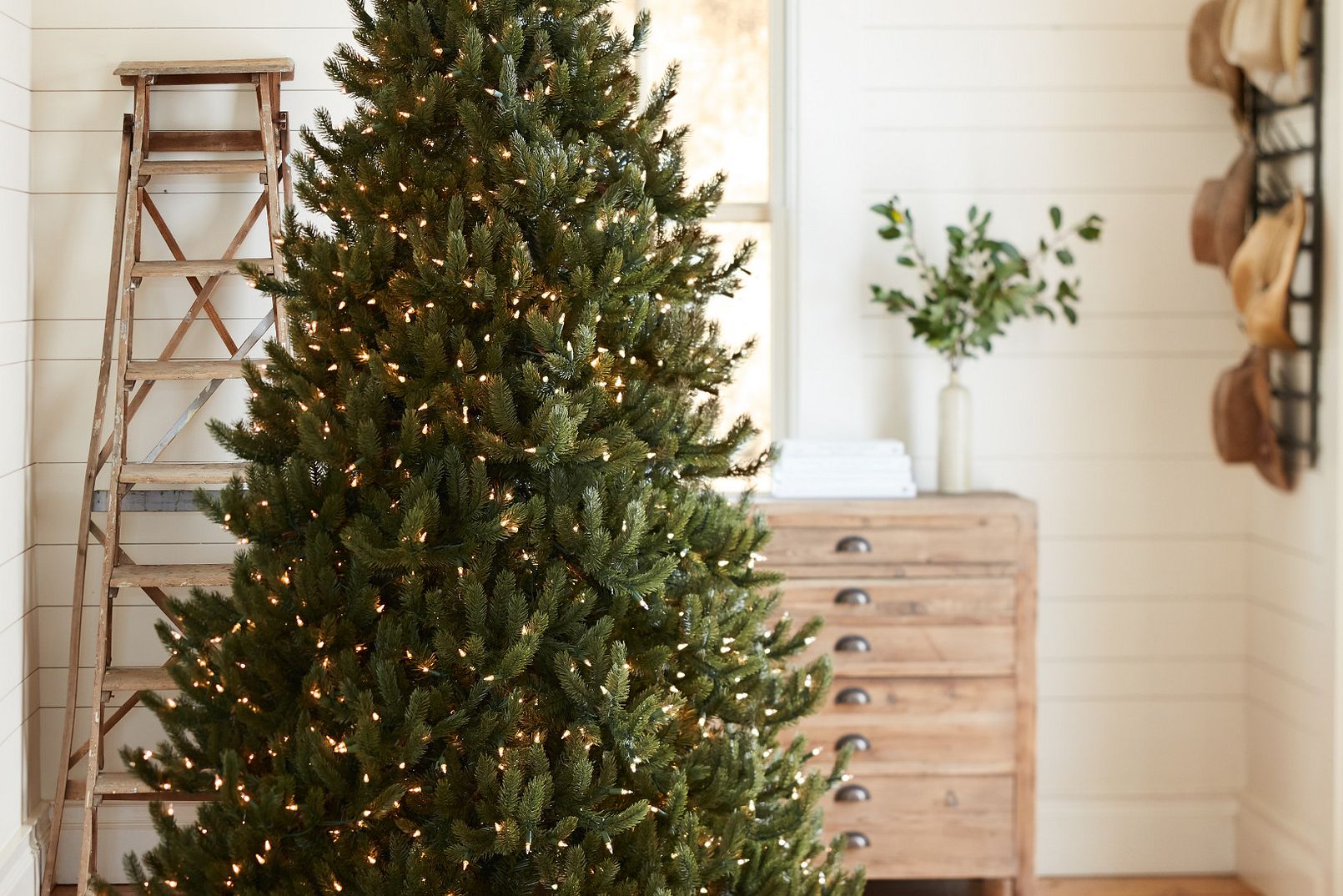 Artificial tree with LED Christmas tree lights in a rustic room