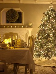 full pre-lit Christmas tree with decorations in the dining room