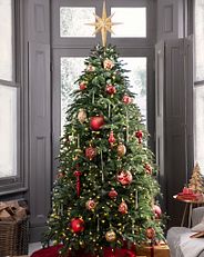 Balsam Hill’s Nordmann Fir artificial Christmas tree decorated with red and gold baubles