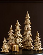 A set of five metallic glitter tabletop trees in varying sizes