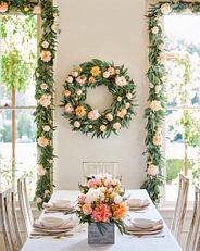 an artificial floral wreath and garland pair in a dining room