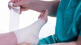 Nurse taping a patient's foot and ankle.
