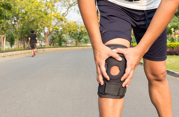 Runner wearing knee brace