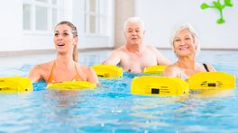 Three people doing water aerobics in a pool.