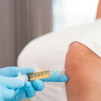 Stem cells being injected into a patient's knee.