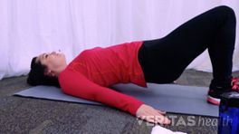 Profile of woman performing the bridging stretch.
