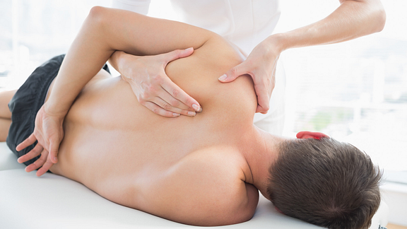 Image of physical therapist manipulating patient's shoulder