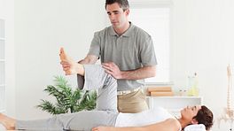 Physical therapist working with a patient's knee