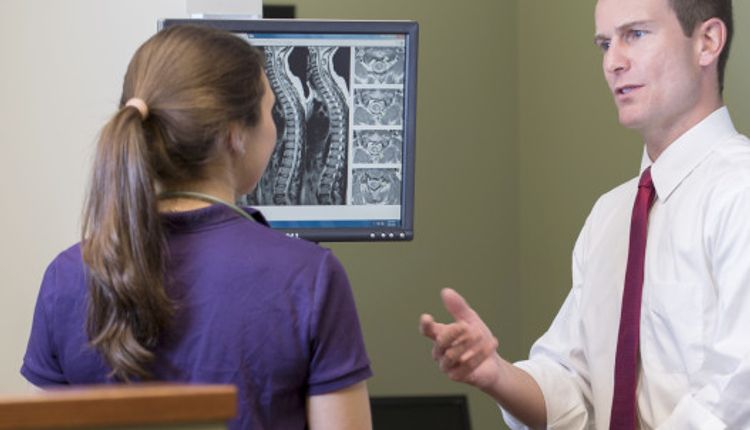 Dr. Scott Meyer, one of five ANS neurosurgeons fellowship trained in spine, discusses the newest treatment options for cervical disc replacement with a colleague.