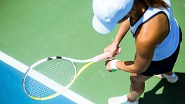 Woman preparing to serve a tennis ball