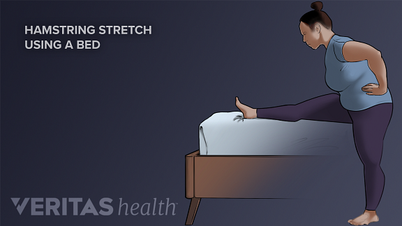 Woman doing a Hamstring Stretch with a bed