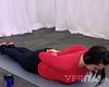 Woman lying prone doing extension exercise.
