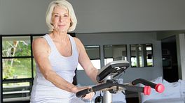 Elderly woman on stationary bicycle