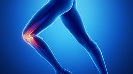 Silhouette of a woman running, her knee is highlighted in red indicating pain