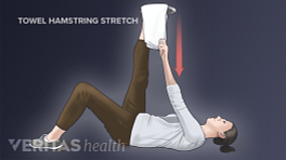 Woman performing the supine hamstring towel stretch for sciatica pain relief