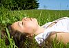 Woman lying down and resting in the grass