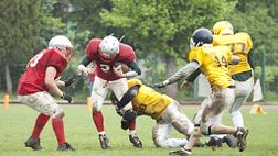 Two teams competing on the football field.