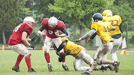 Two teams competing on the football field.