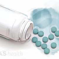 Bottle of NSAID pills spills on the tabletop.