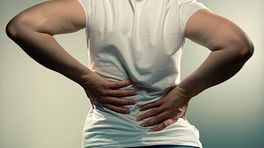 Woman grabbing her back in pain