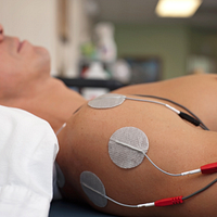 Image of person getting transcutaneous electrical nerve stimulation TENS therapy on their shoulder