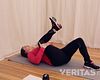 Woman lying supine doing Single Knee to Chest SI Joint Stretch