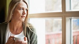 Woman gazing sadly out of the window