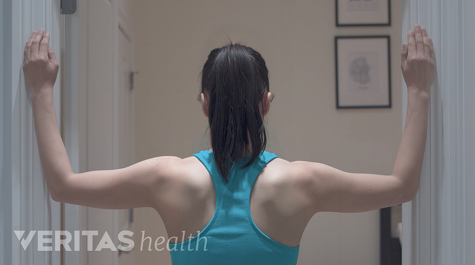 image of woman doing the corner stretch for neck pain relief
