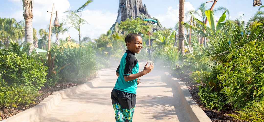Volcano Bay™ at Universal Orlando Resort Boy walking towards the volcano at Volcano Bay at Universal Orlando Resort