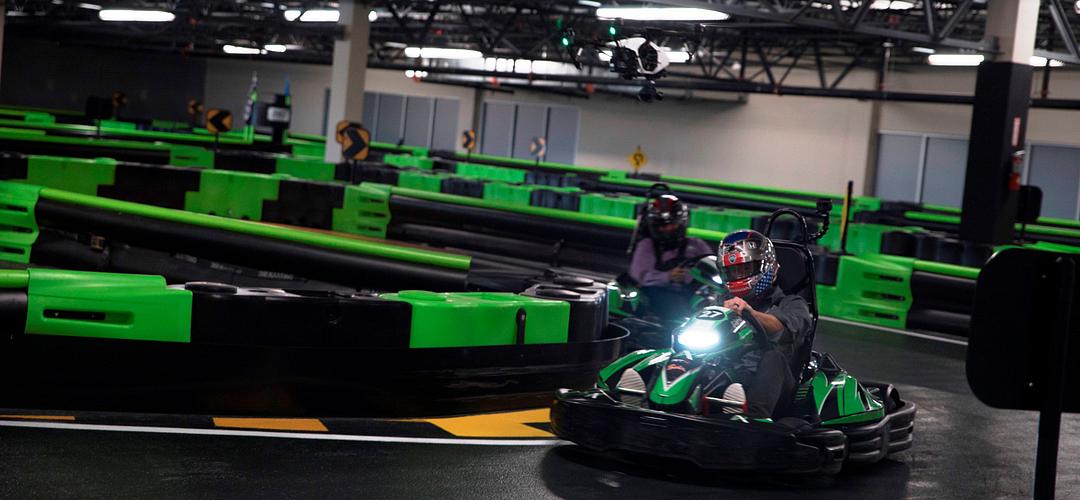 Andretti Indoor Karting & Games Person driving kart on track at Andretti Indoor Karting & Games