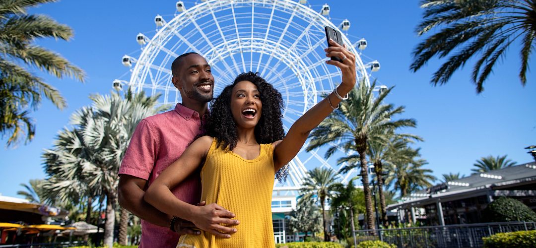 The Wheel at ICON Park A couple taking a selfie in front of the Wheel at ICON Park.