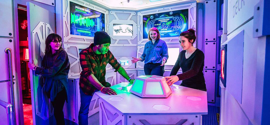 The Escape Game Teenagers solving clues inside of The Escape Game