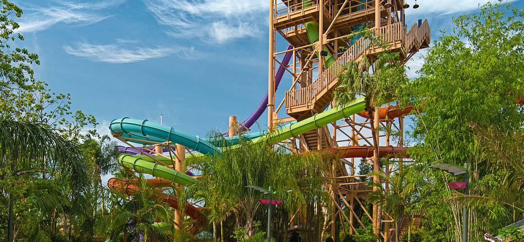Aquatica Ihu breakaway slides Three people descending on a race to the bottom of the water slides at Aquatica Ihu's breakaway falls